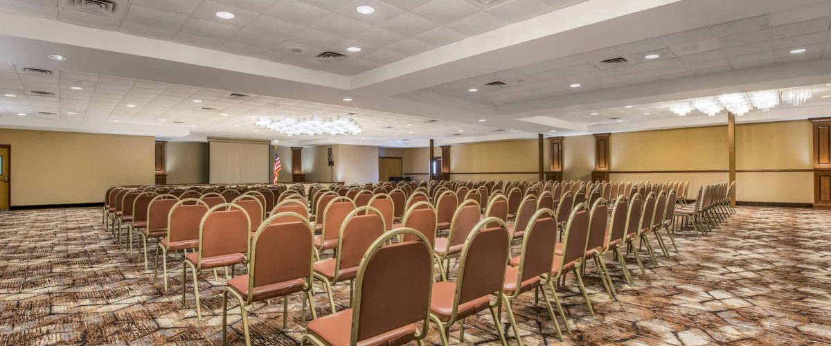 Large conference room with rows a chairs